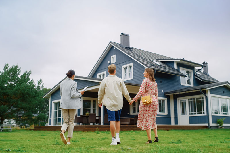 Real Estate Agent Showing a Beautiful Big House Real Estate Agent Showing a Beautiful Big House